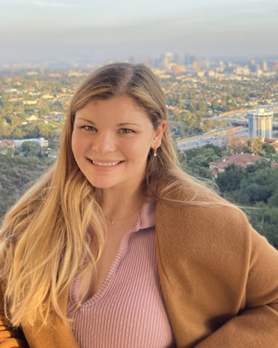 Megan Cole poses in front a scenic skyline