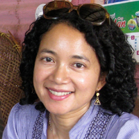 Fatimah Rony smiling and wearing a purple blouse. 