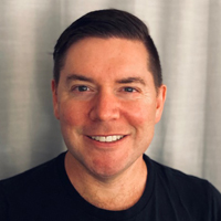Lucas Hilderbrand smiling and wearing a black shirt. 
