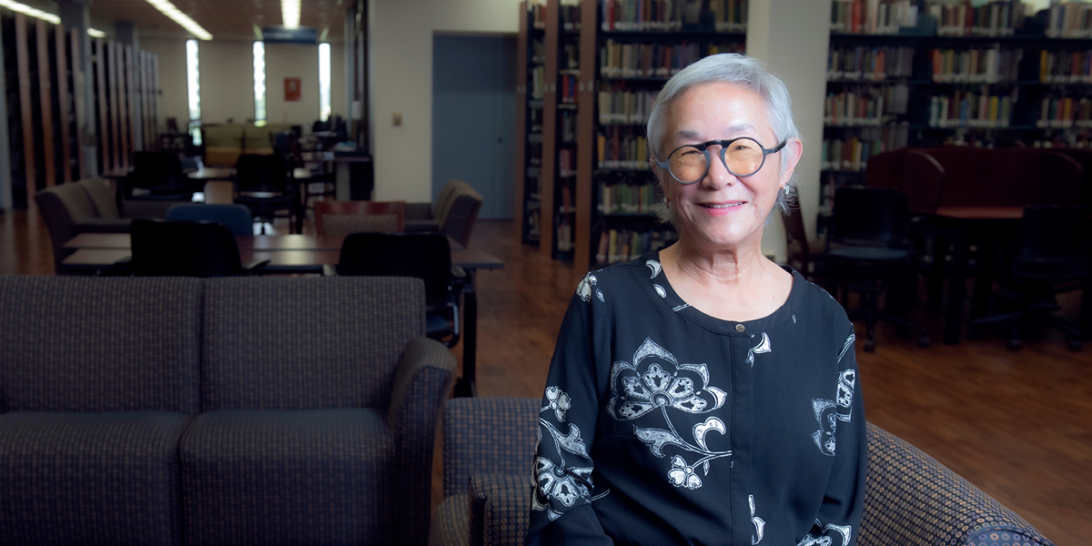 Christina Woo sits inside of Langson Library