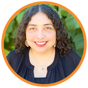 A headshot of Ana Rosas against a background of foliage