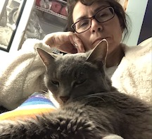 a woman and her sleepy cat take a selfie together