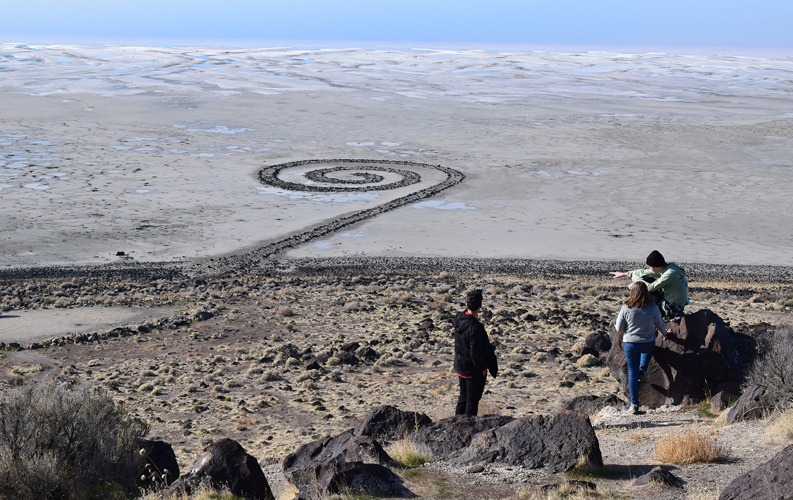 A group of students gaze at the Spiral Jetty