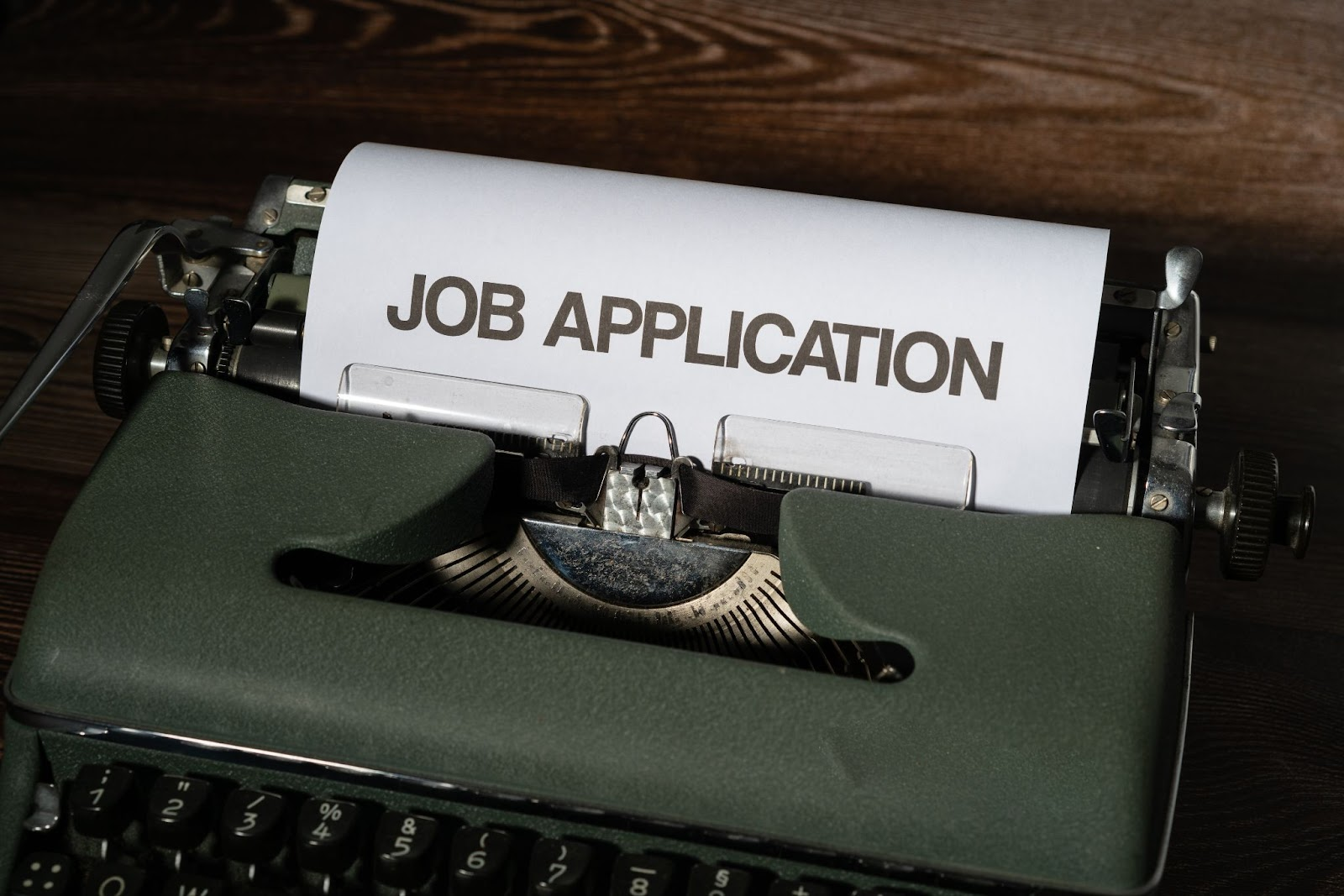 Type writer with the words "Job Application" on the paper