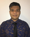 Photo of Ricardo Lopez in front of a beige wall wearing a purple shirt and a black tie.