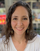 Picture of Mercedes Trigos smiling with brown hair and a white shirt.