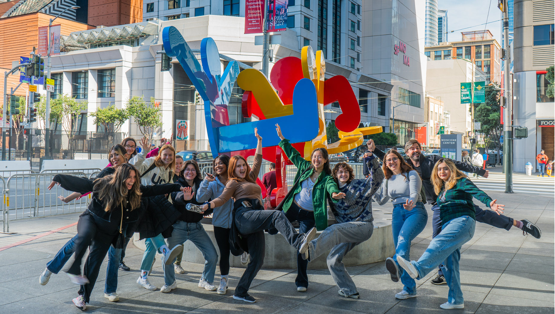 Group of art history students posing silly in front of SFMOMA