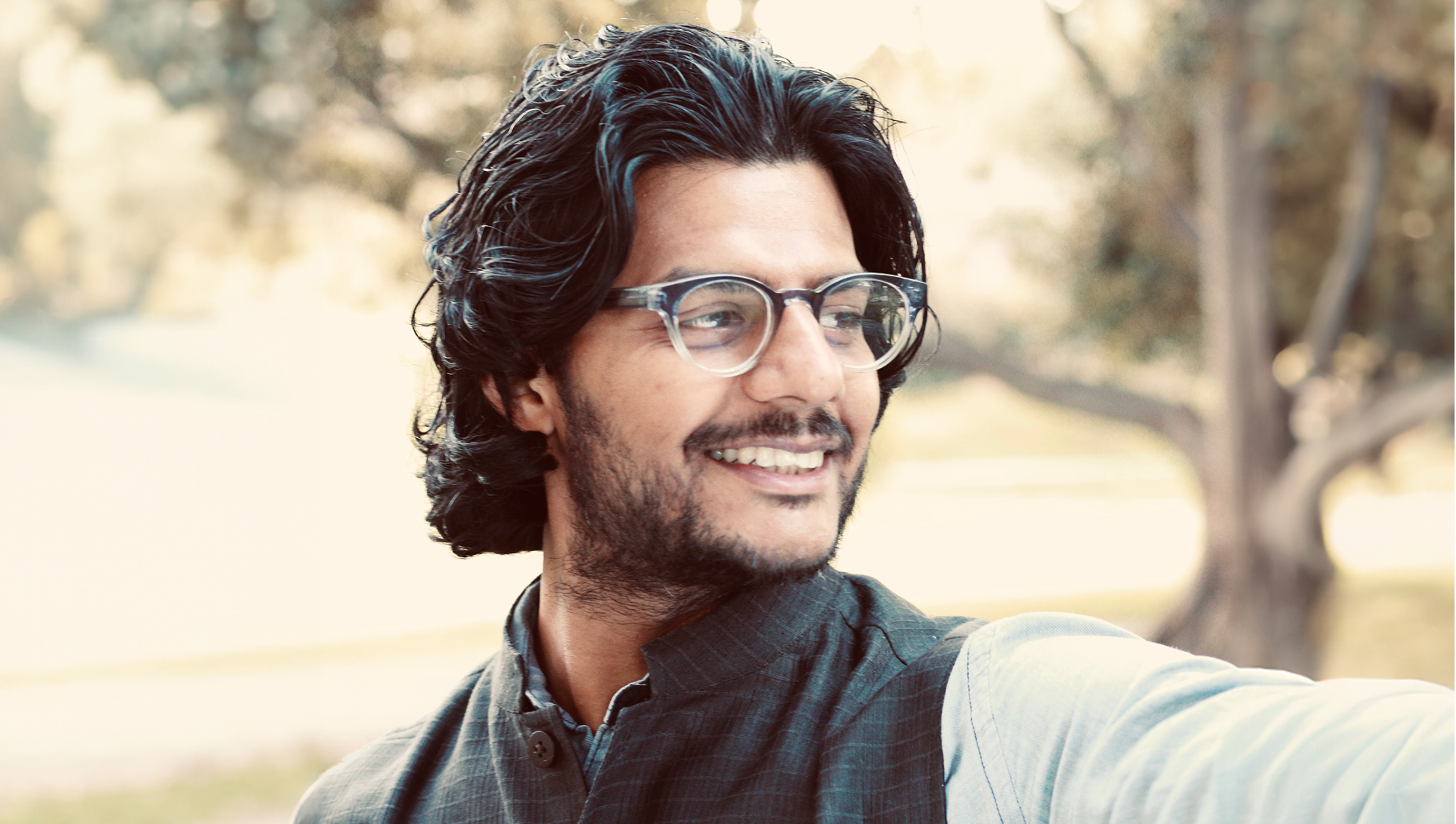 A headshot of Anirban Gupta-Nigam in a park.