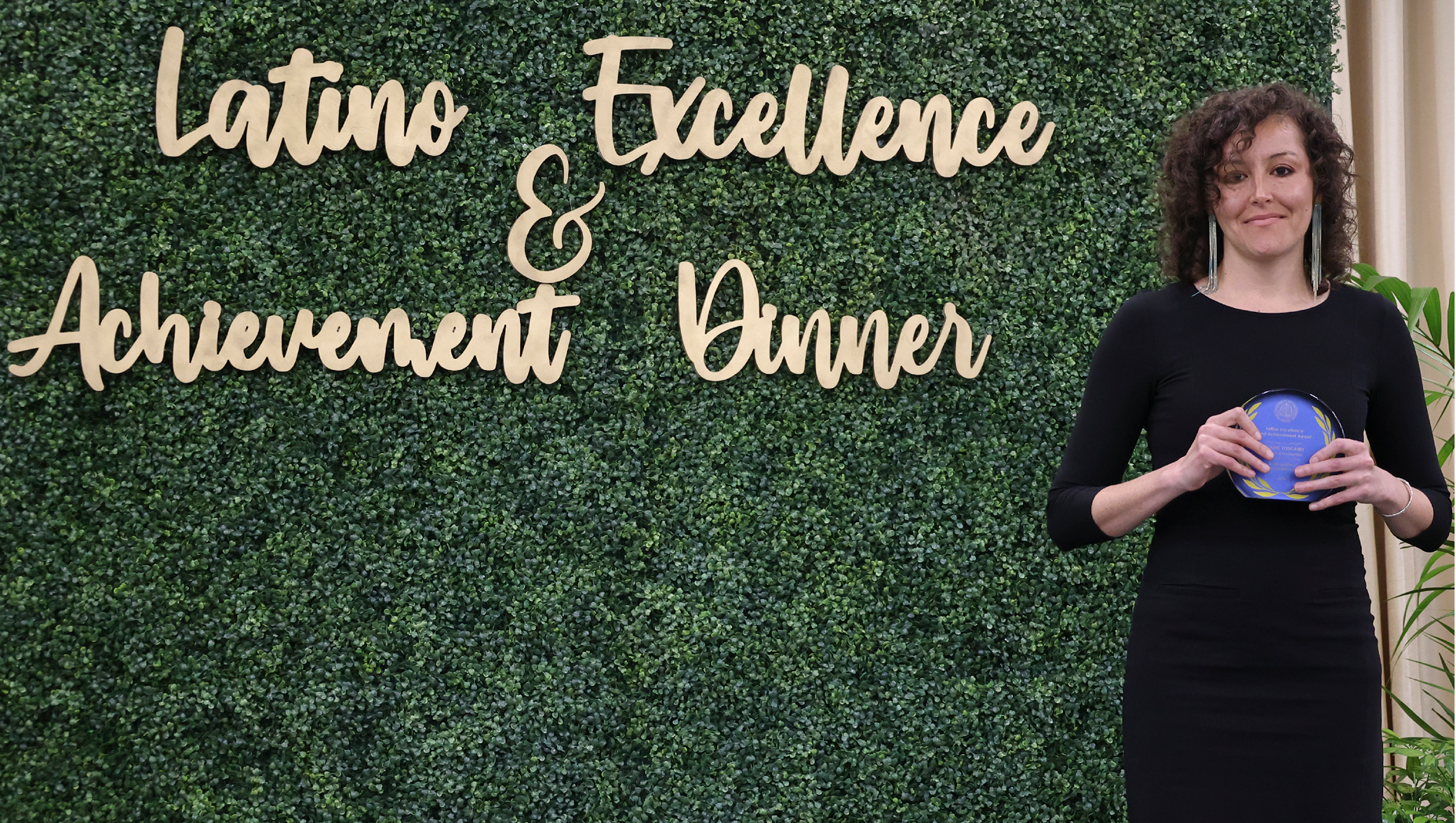 Jeanie Toscano UCI Spanish and Portuguese Ph.D. student wins LEAD Award. She is standing next to the LEAD sign.