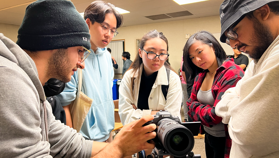 Student looking at a camera together