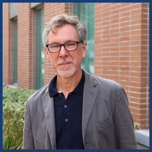 Professor-James-A.-Steintrager standing in front of a brick wall.