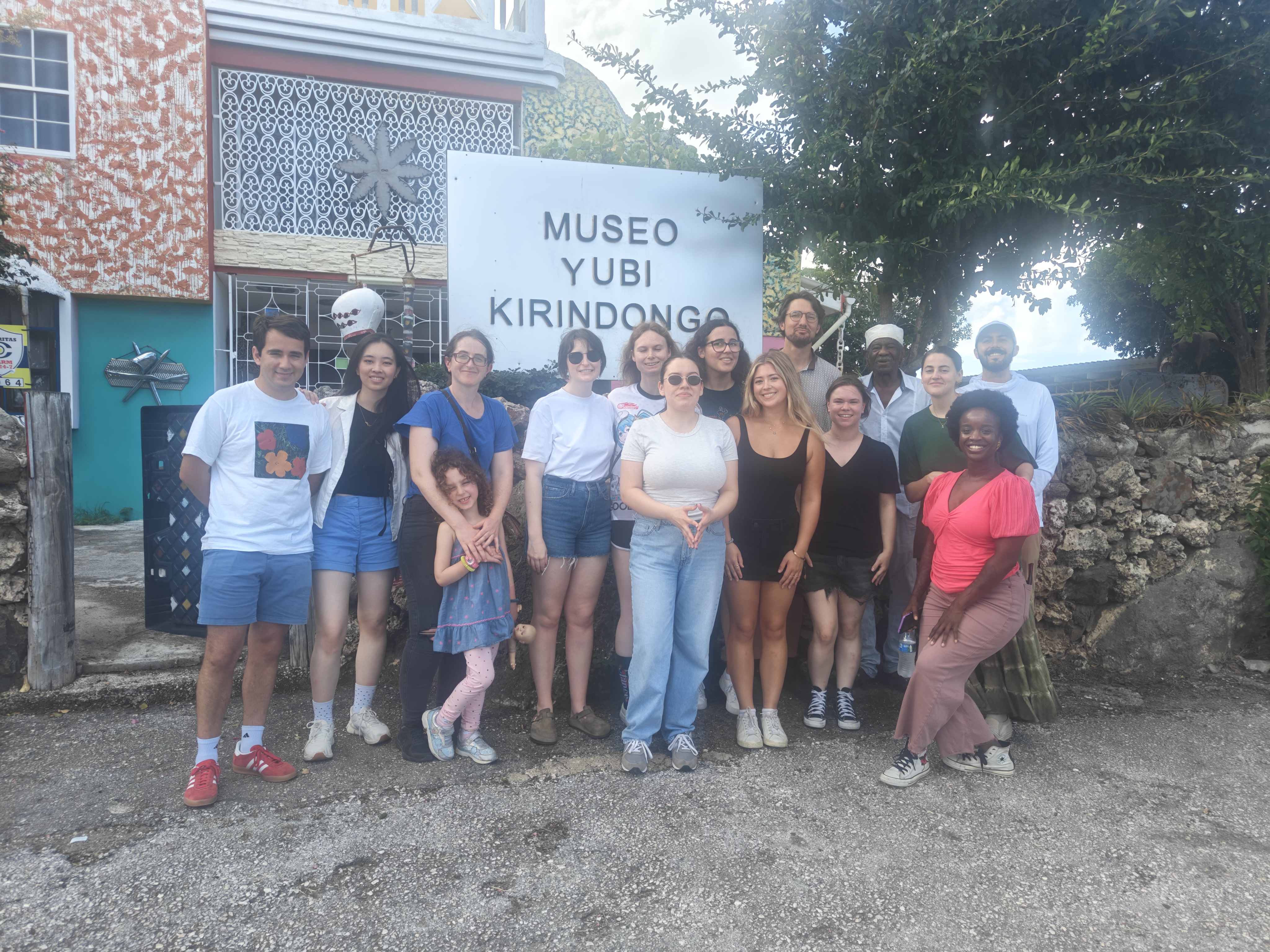 Students standing in front of an artist's studio.