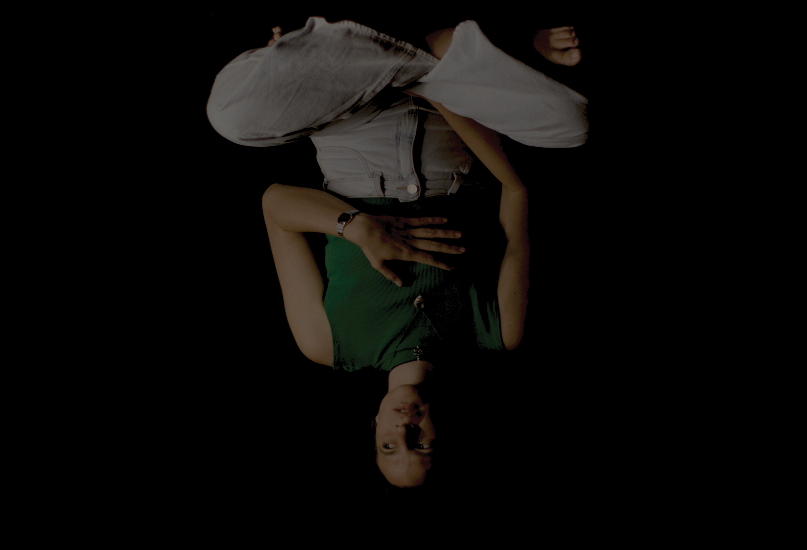 A still from the film Alma: A woman sits cross legged, upside down. 