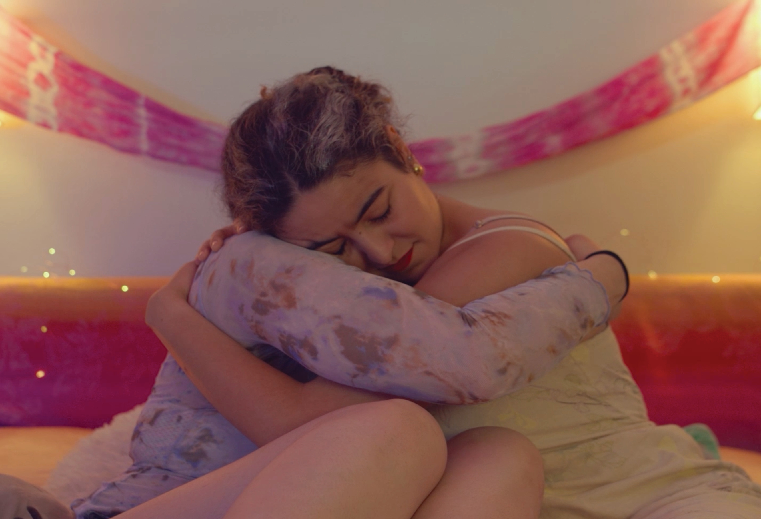 A still from the film La Flor Mas Hermosa: Two woman hug
