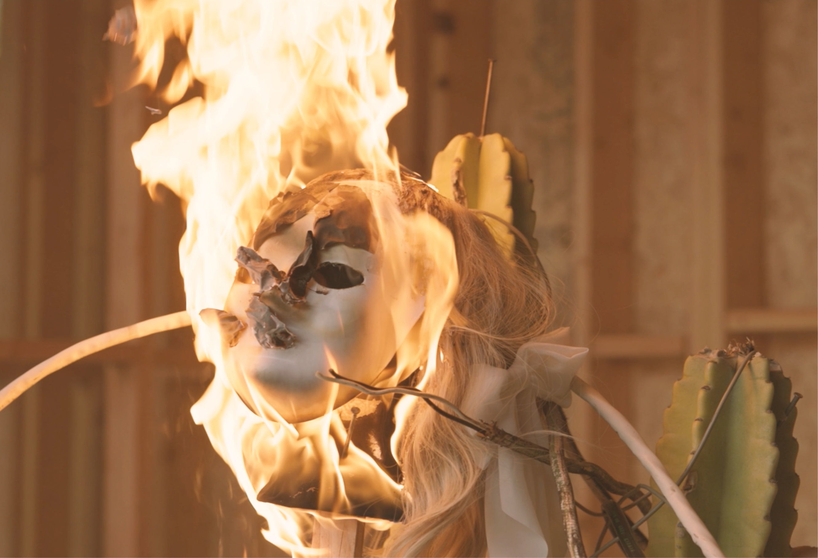 A still from the film Haiyi Yu, feature a white mask on fire.