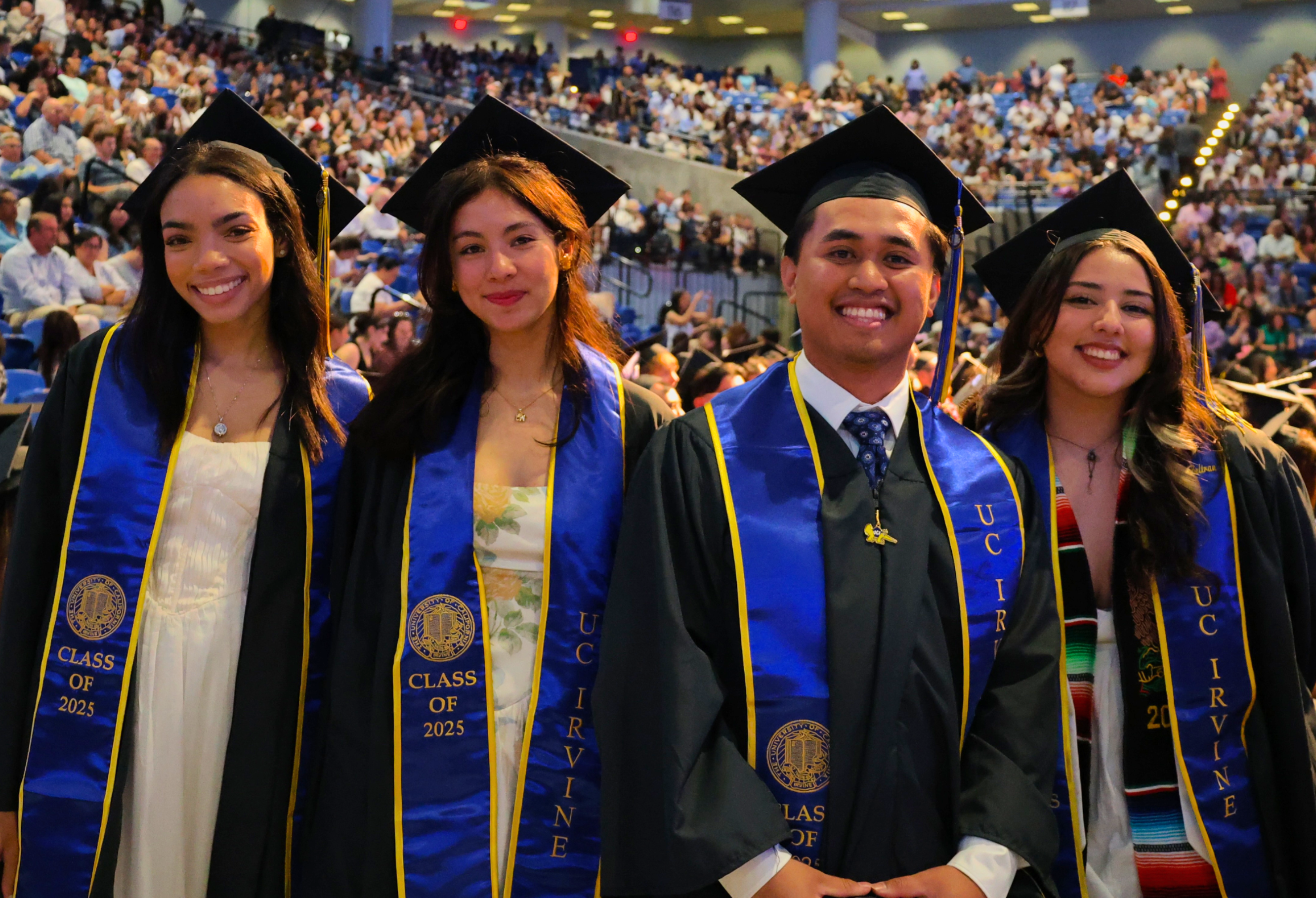 Four FMS students wearing caps and gowns