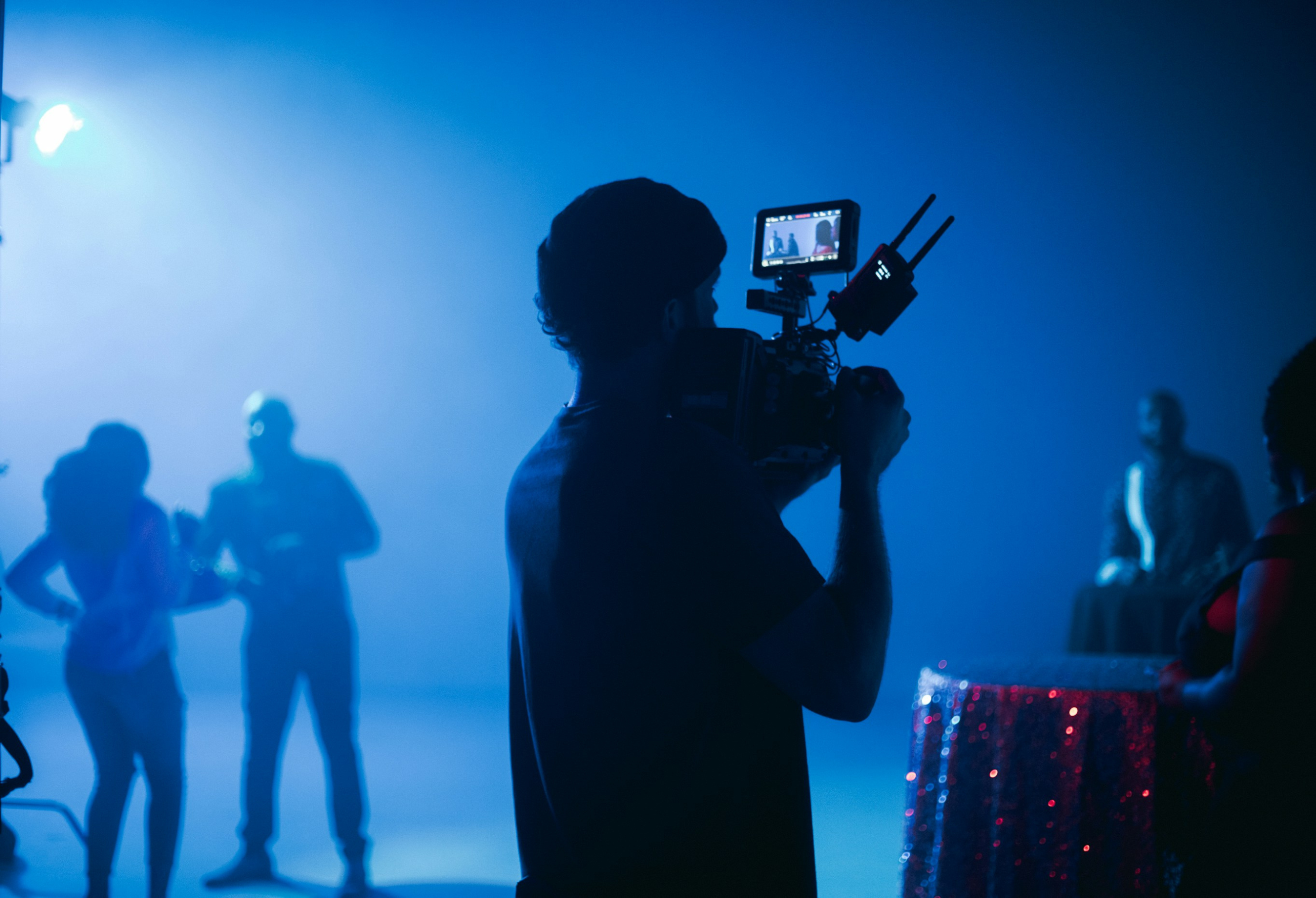 A person holding a camera and filming a scene