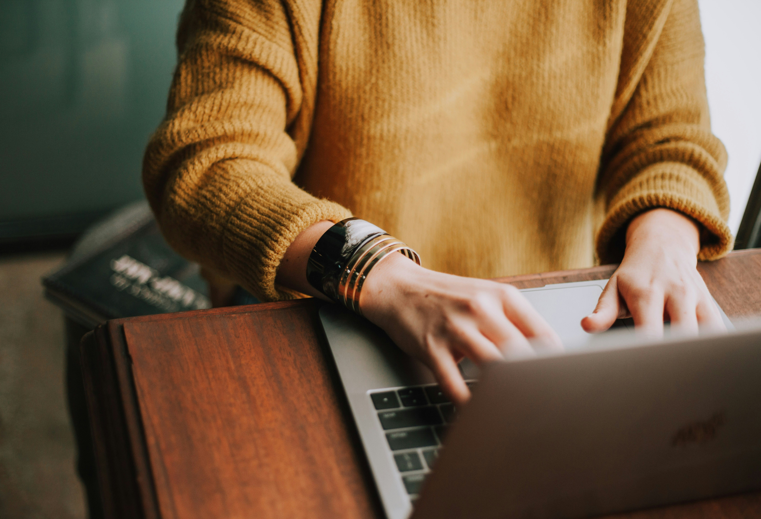 A woman typing on a laptop