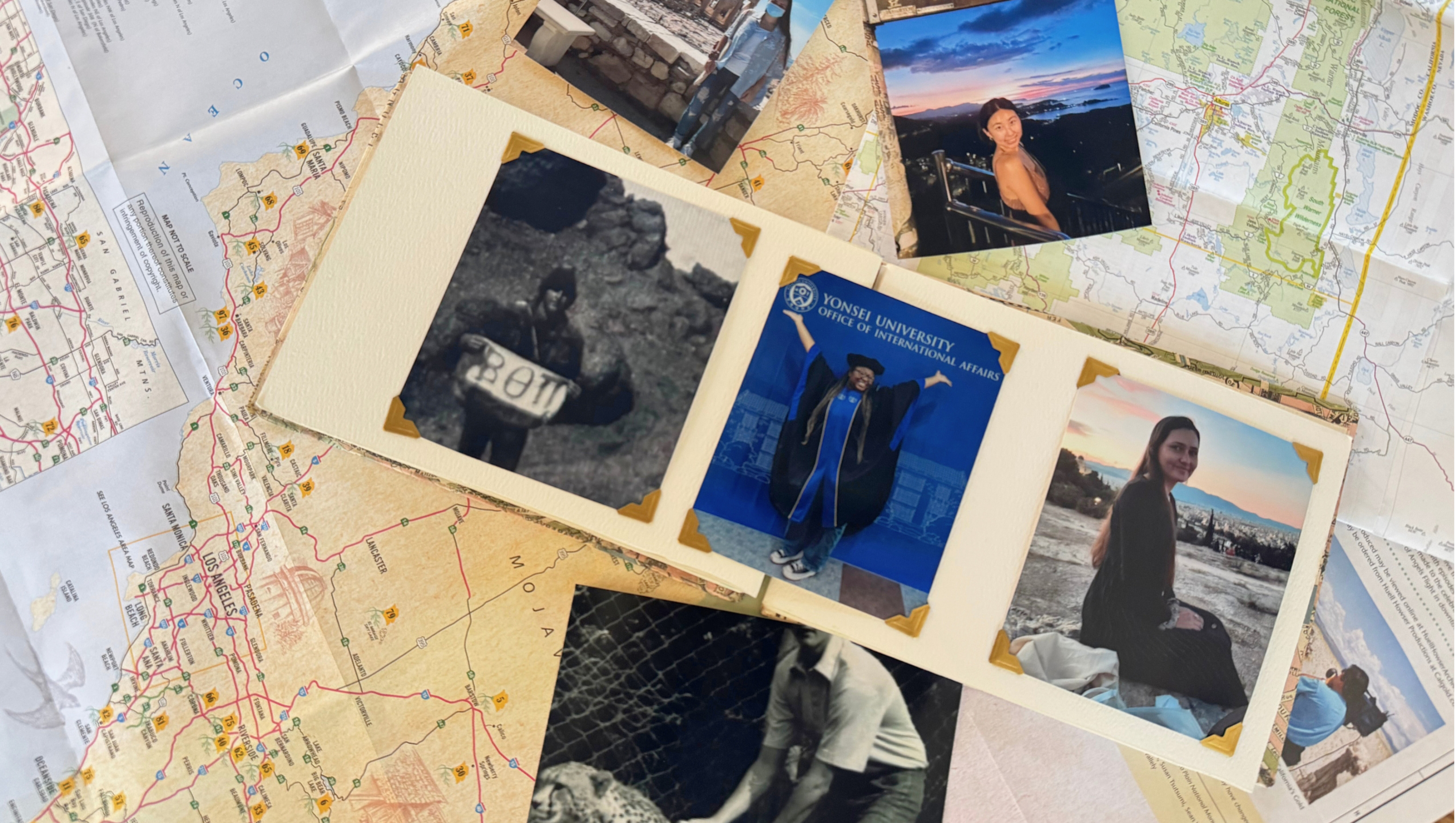 Printed out photos of students studying abroad with a map laid out in the background