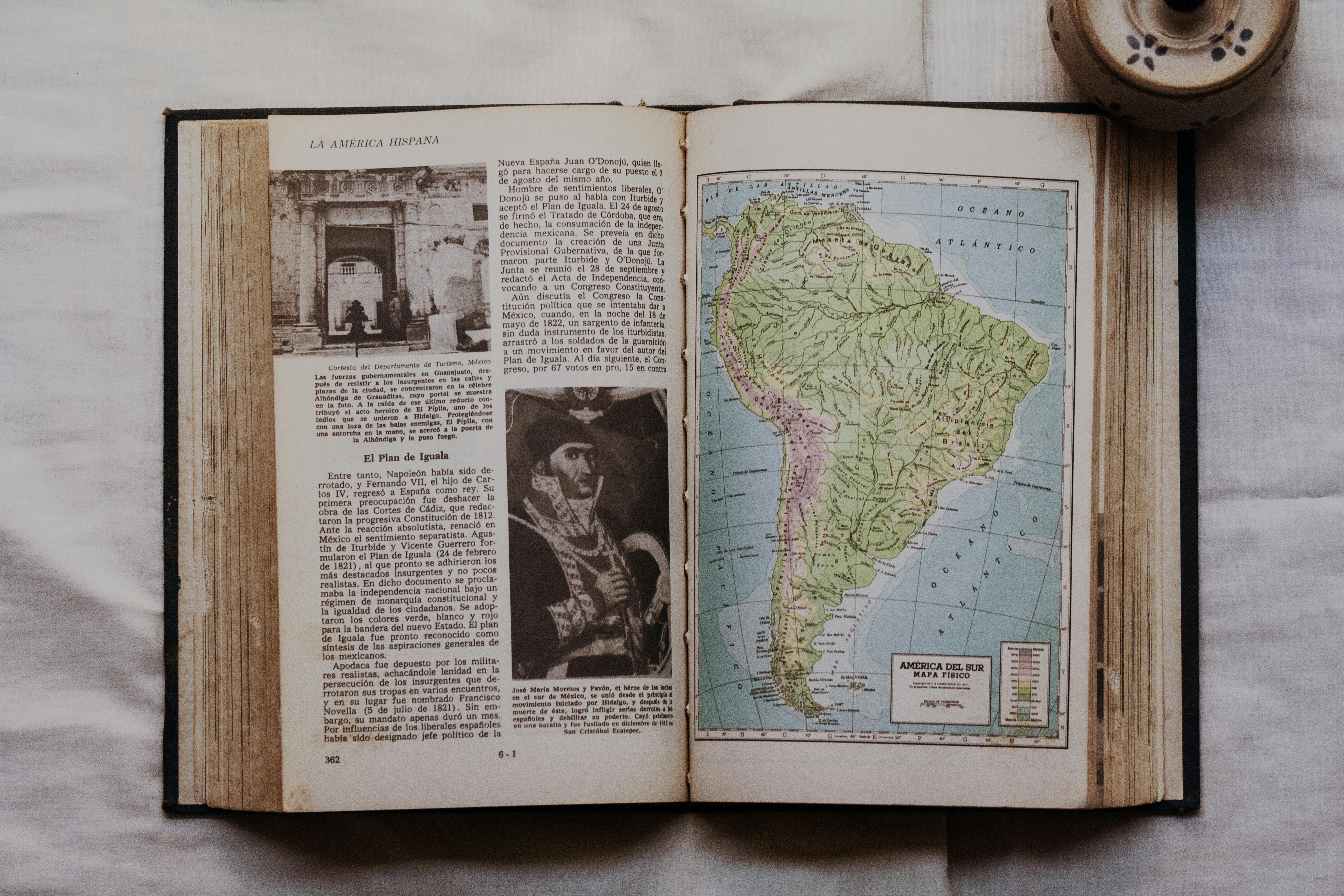 An open book displaying a map of South America and historical text