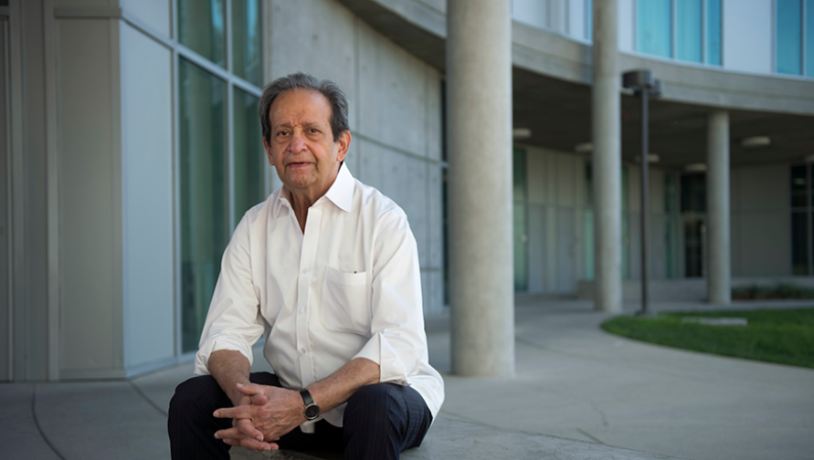 Aijaz Ahmad is at the courtyard of Humanities Gateway, sitting on a bench