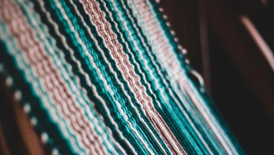 pastel woven threads on a loom