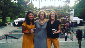 3 woman smiling at the camera next to each other on stairs