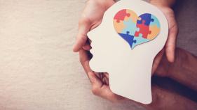 Hands holding head with heart image inside