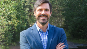 Picture of Professor James Nisbet surrounded by trees