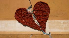 two pieces of red crocheted heart split apart and resewn