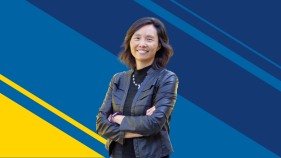 A portrait of Judy Wu against a navy blue and gold background