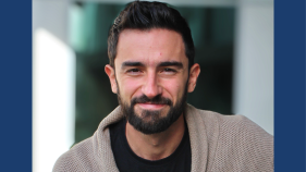 A headshot of Juan Manuel Rubio with a blue background