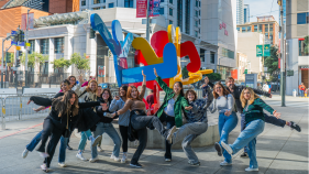 Group of art history students posing silly in front of SFMOMA