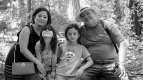 Rodney Hironymous, his wife and two daughters posing for a photo