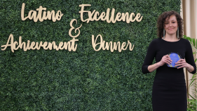 Jeanie Toscano UCI Spanish and Portuguese Ph.D. student wins LEAD Award. She is standing next to the LEAD sign.