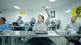 A student in the LIFTED program has his hand up in the classroom.