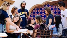 students gathering by tables