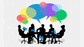 People sit at a desk holding books and talking represented by speech bubbles