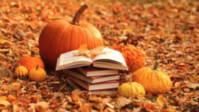 Fall leaves, pumpkin, and books