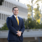 Ian Massey smiling in front of a UCI building