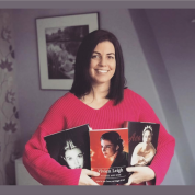 Kendra Bean holding 3 books in her arms with the covers facing outward