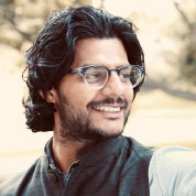 Head shot of Anirban Gupta-Nigam in a park