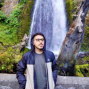 Headshot of Dante Garcia in front of a waterfall