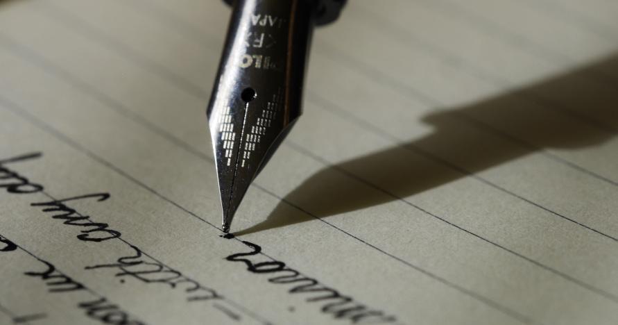 A pen writes on paper