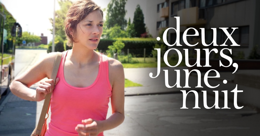 A woman wearing a pink tank top looks off to the side
