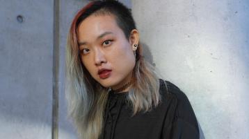 Monica Guo posing against a wall