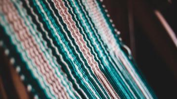 pastel woven threads on a loom