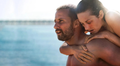 A woman holding onto the back of a man