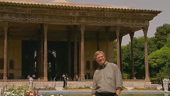 Man posing in front of traditional landmark