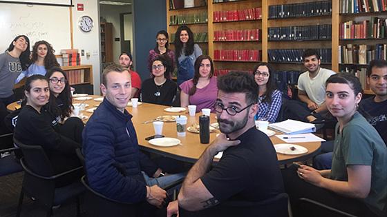 persian club smiling around a table